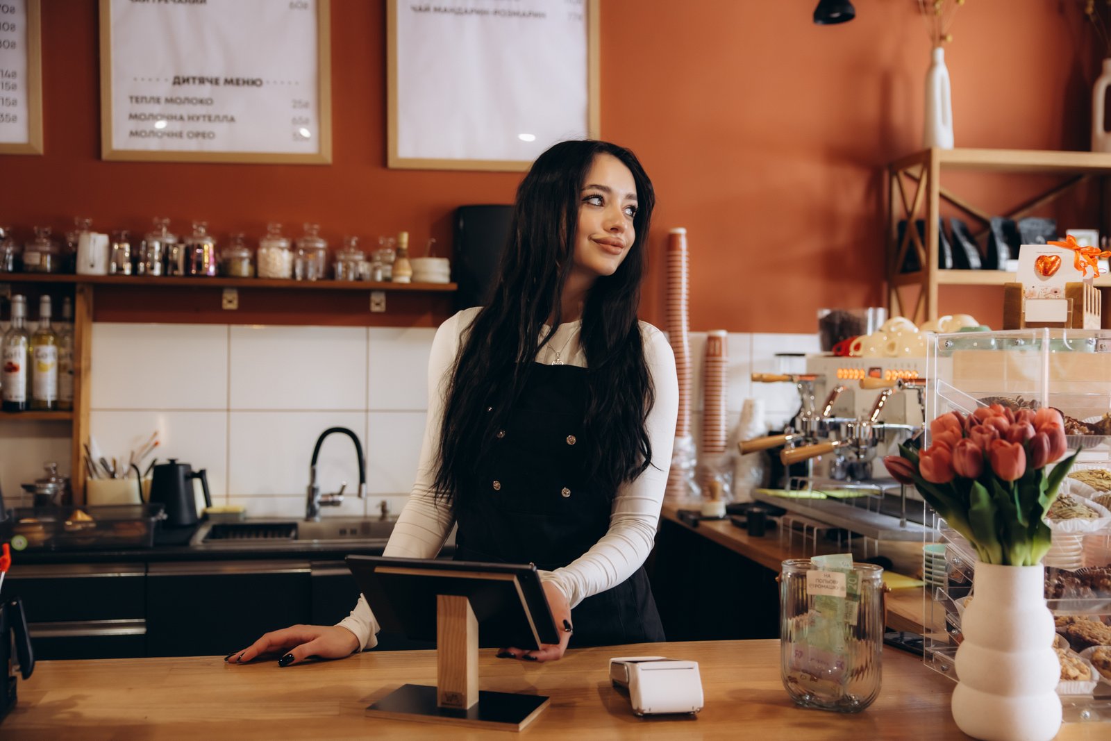 Small business owner behind the counter of her shop
